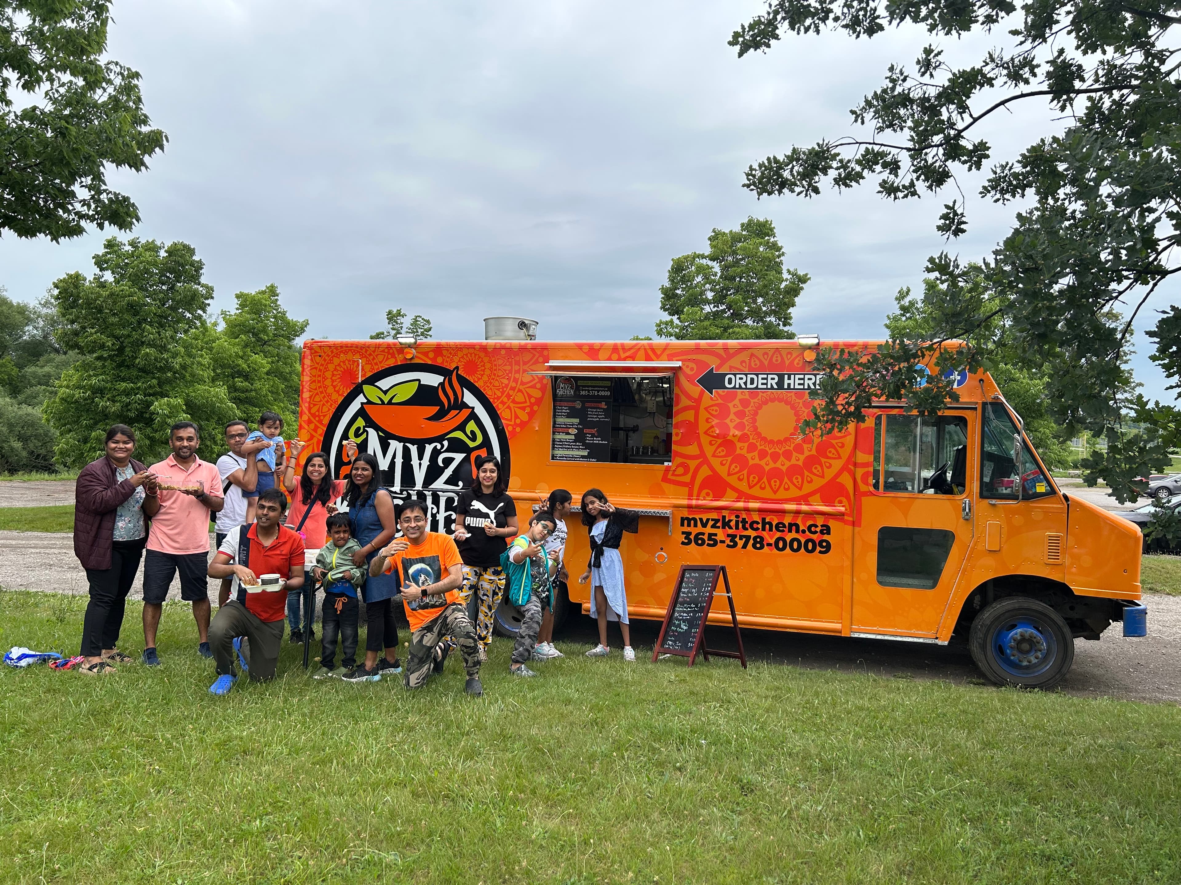 A group of customers outside the MV'z Kitchen Food Truck in Kitchener, Ontario